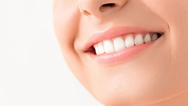 Close Up Of Woman Smiling With A Dental Crown Lengthening 