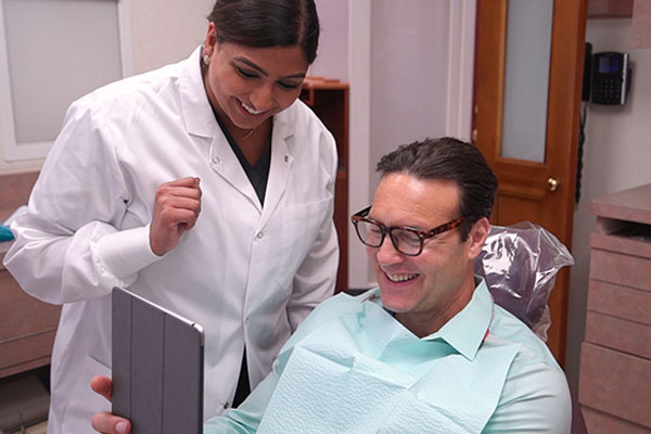 Tooth shade guide being held up to teeth